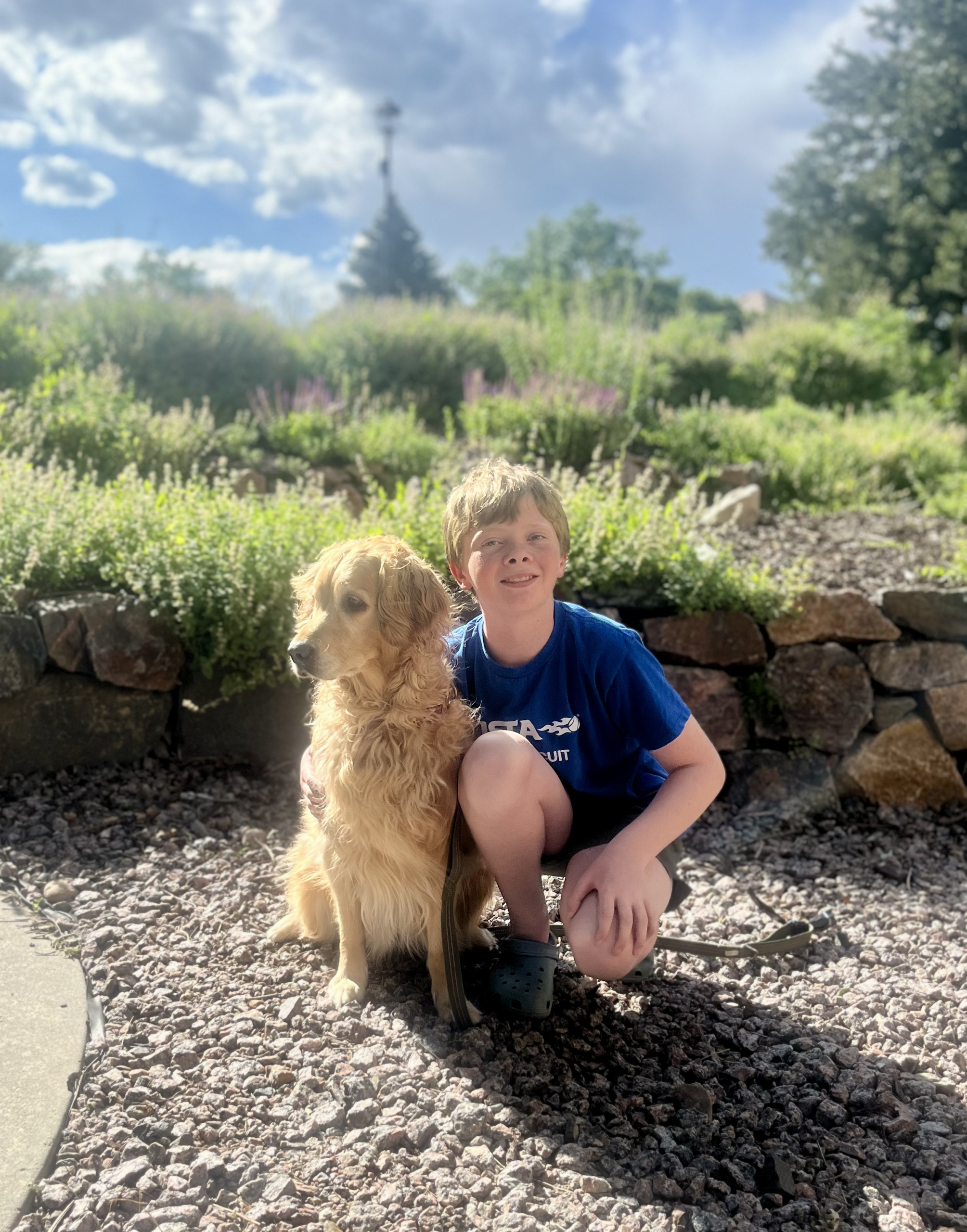 Griffin next to his dog, a golden retriever, Lila